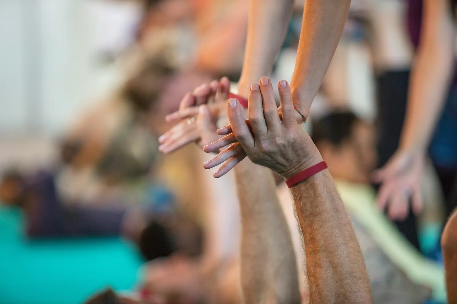 Several hands stacked together – a symbol of support and being accompanied