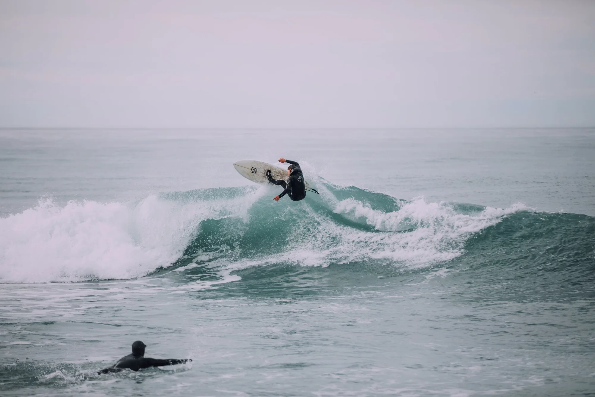 Person surfing a wave in the ocean